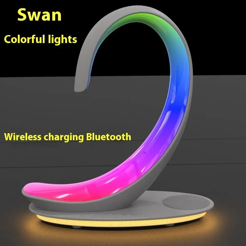 White swan shaped desk lamp with wireless charging pad, Bluetooth speaker and colourful LED lighting