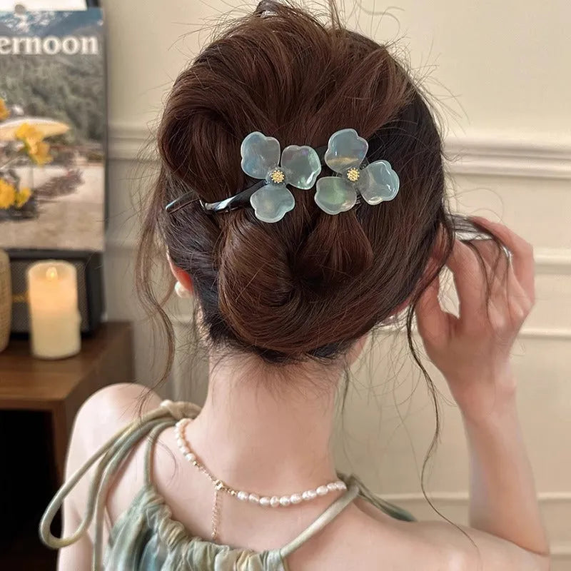 Retro flower petal bobby pin hair accessory in acrylic, shown on a background.