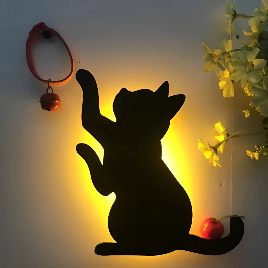 Cat-shaped LED night light with sound sensor on a wall, emitting warm yellow light.