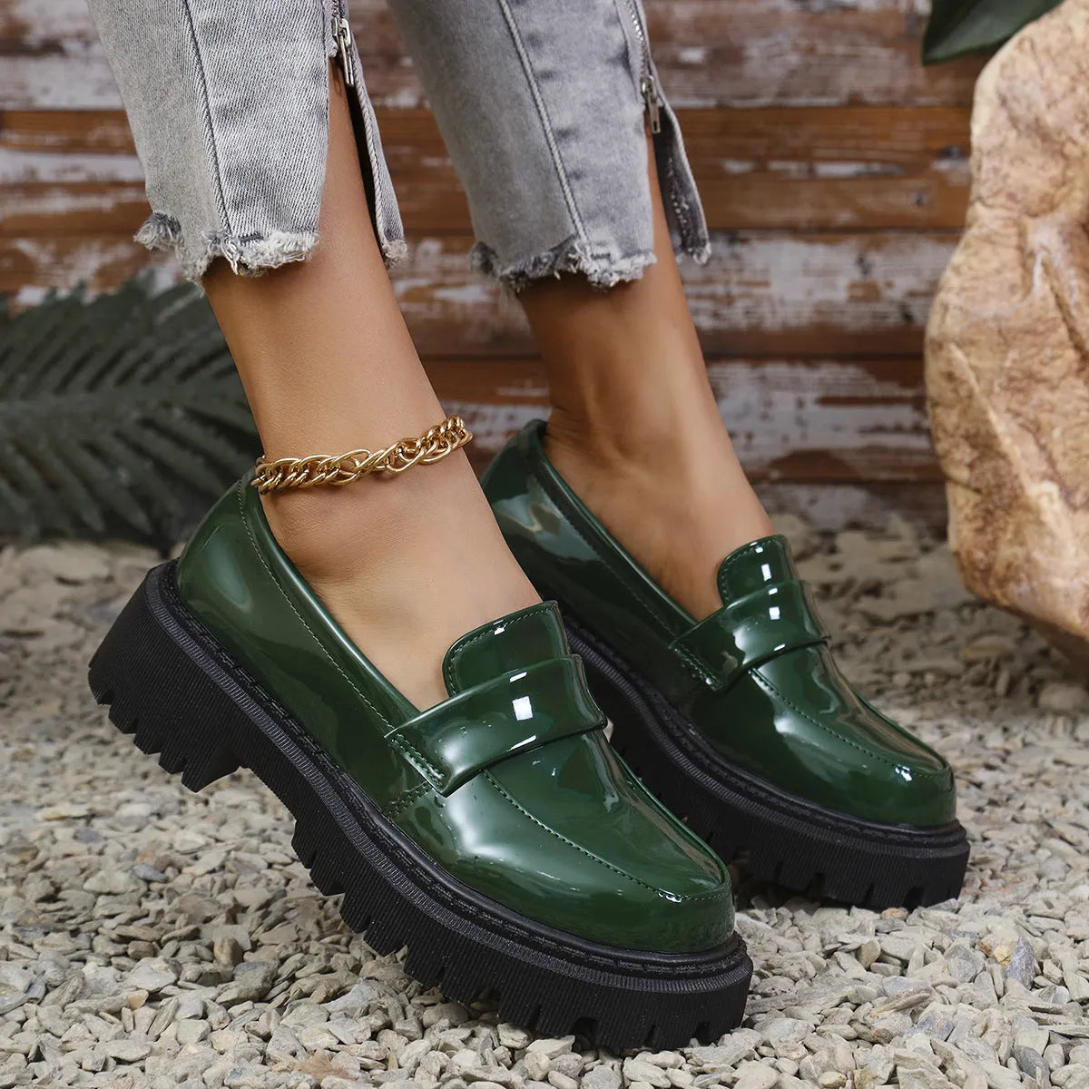 Plus size women's black slip-on loafers with a chunky platform heel and thick rubber sole.