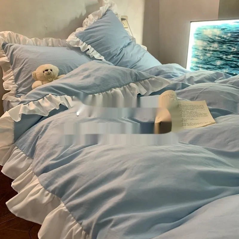 Washed cotton Mori style quilt cover bedding set in solid blue, laid flat on a bed.