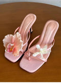 Women's handmade asymmetric flower design sandals with a high heel in calf leather.