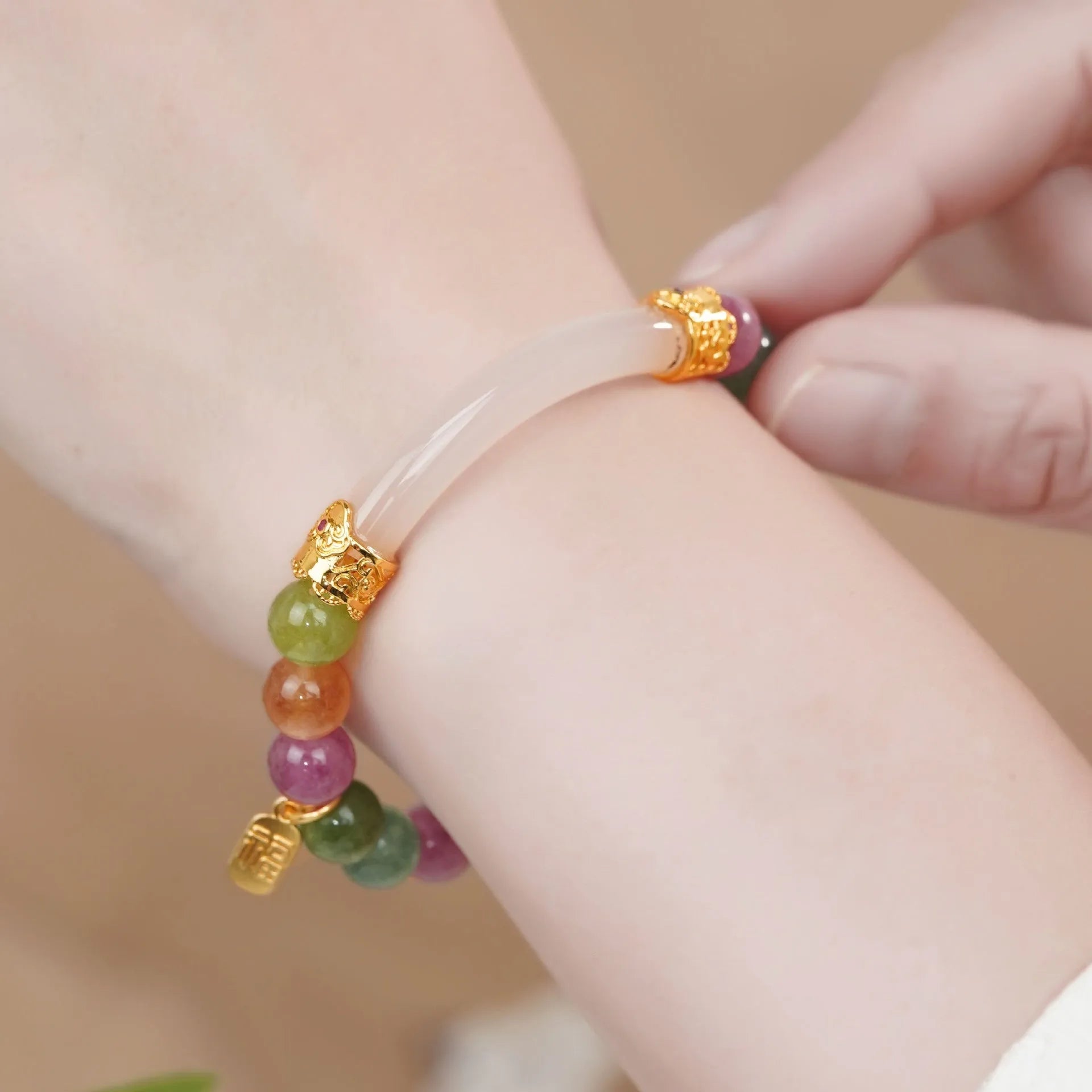 Rainbow coloured tourmaline half bracelet for women with an electroplated finish.