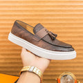 Men's black casual leather shoes with fringe detail on round toe, low heel.