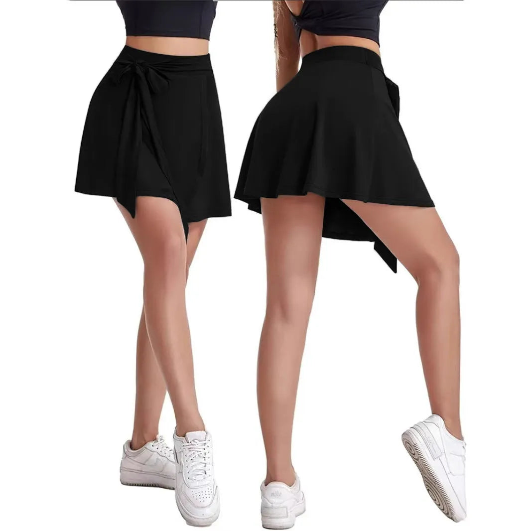 Black thigh-length sports skirt with built-in shorts and adjustable shoulder strap