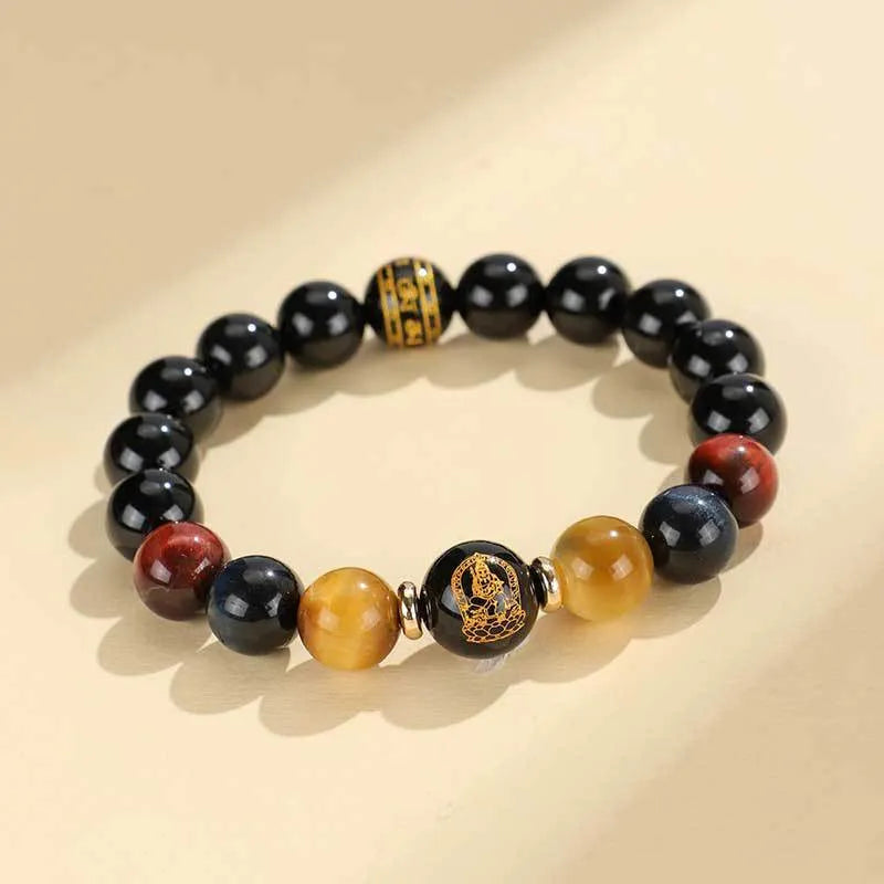 Handmade black agate bracelet with zodiac animal charms and gold tiger eye beads on wrist