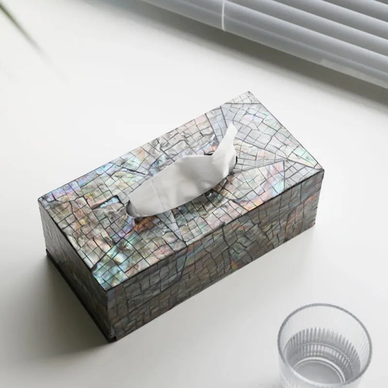 Natural shell decorative storage box in a minimalist design on a coffee table.