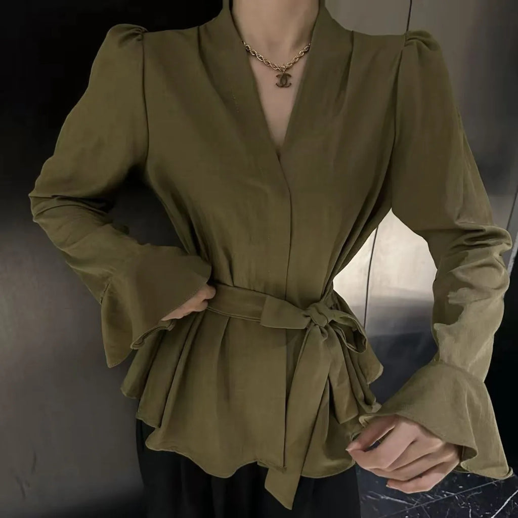 Women's black French-style shirt with irregular collar, long bell sleeves, and a tied front.