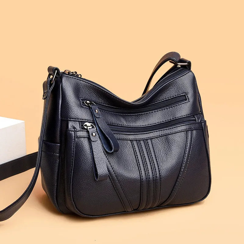 Genuine leather shoulder messenger bag in horizontal square shape with multiple internal compartments and single strap