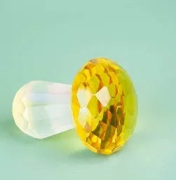 Colourful geometric mushroom crystal decorative ornament in transparent, green, red, or yellow.