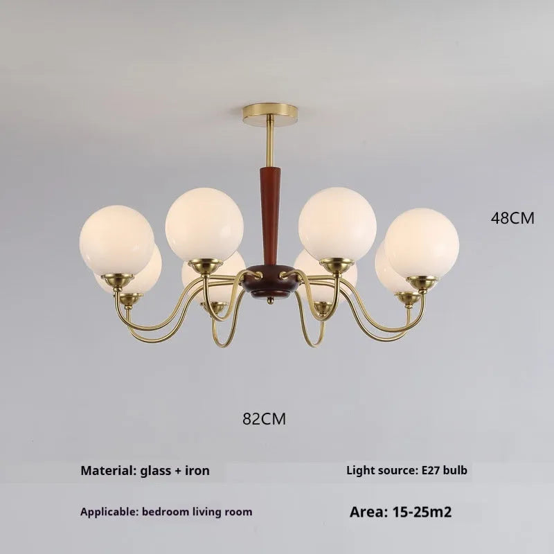 American retro persimmon chandelier with amber yellow glass shades in a dining room setting