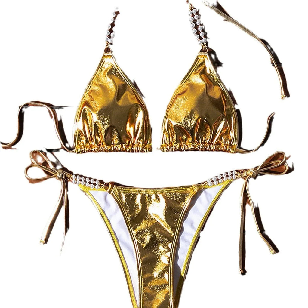 Gold halter neck bikini top with lace-up front and matching briefs, featuring pearl chain detail.