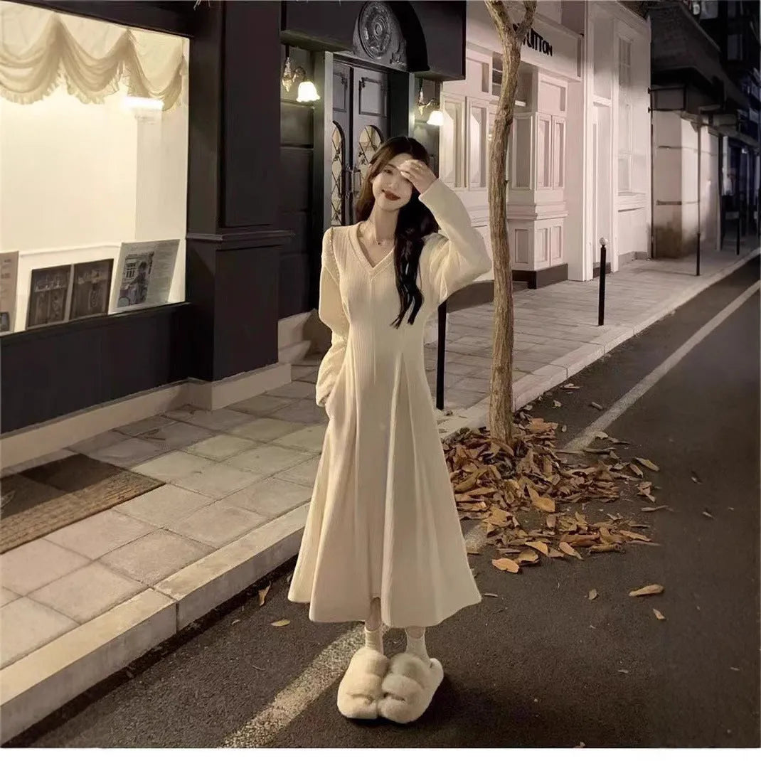 Women's white V-neck knitted dress with long princess sleeves and suspender skirt silhouette