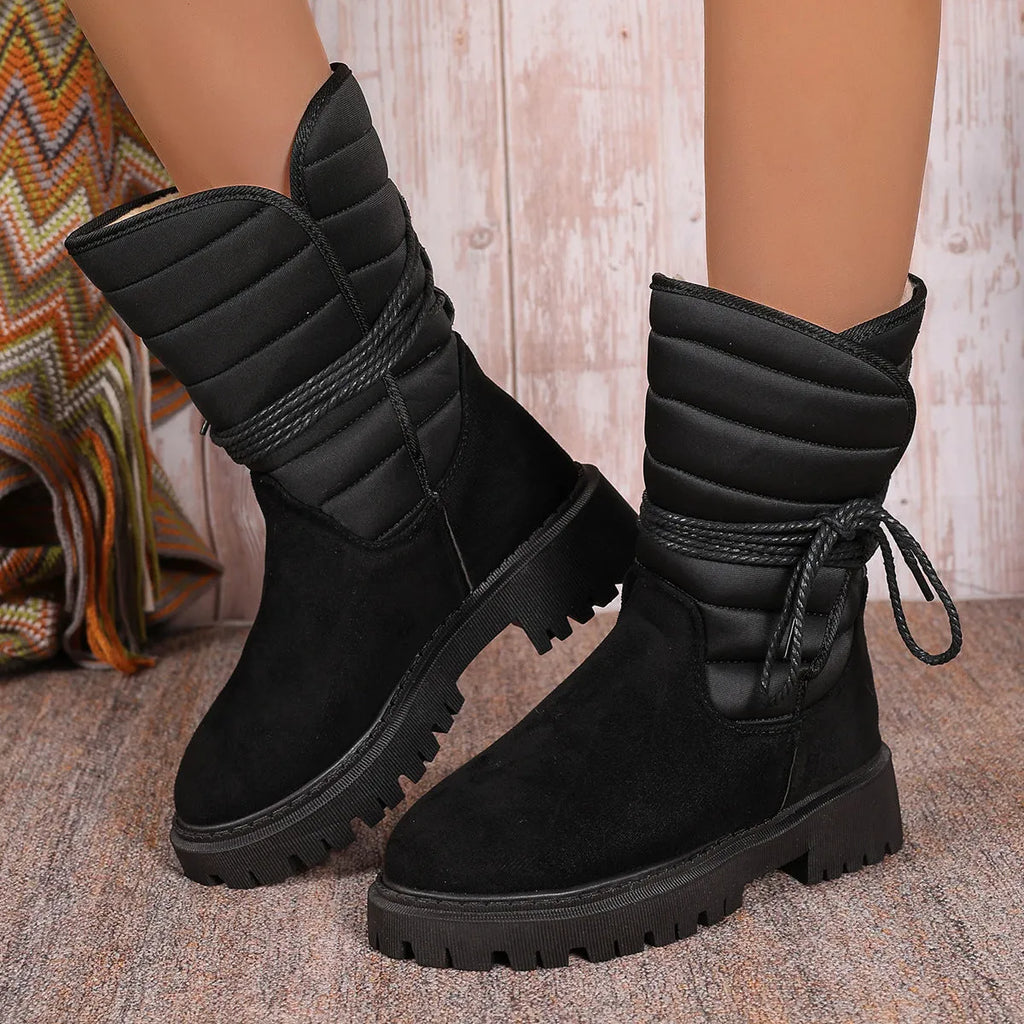 Women's black suede chunky heel snow boots with lace-up design and fleece lining.