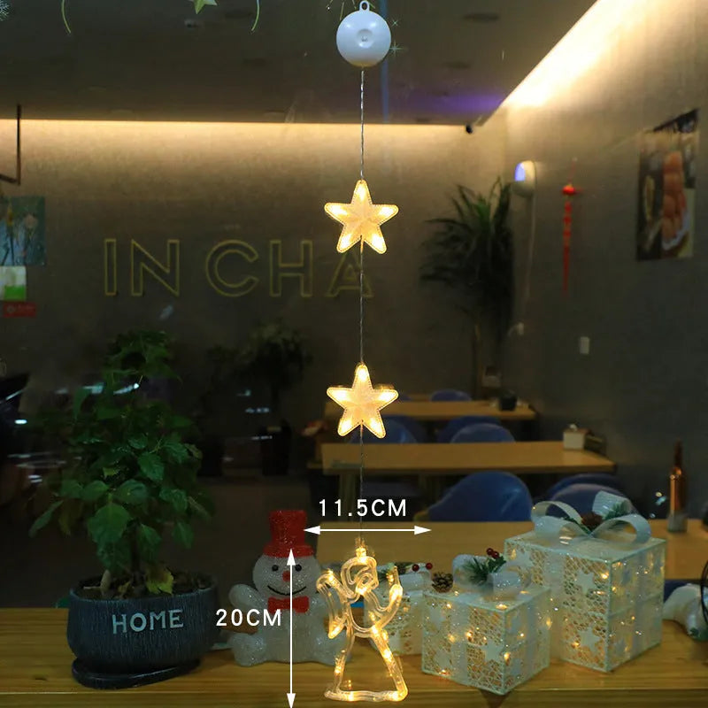 Three Christmas LED light ornaments with suction cups hanging on window