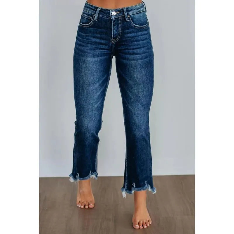 Women's solid blue casual denim trousers with a hand-worn finish on a hanger.