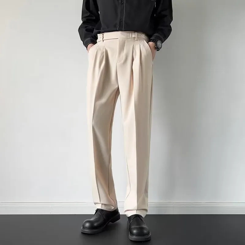 Man wearing straight-loose fit suit trousers in apricot colour, showcasing the leg cut and formal style.
