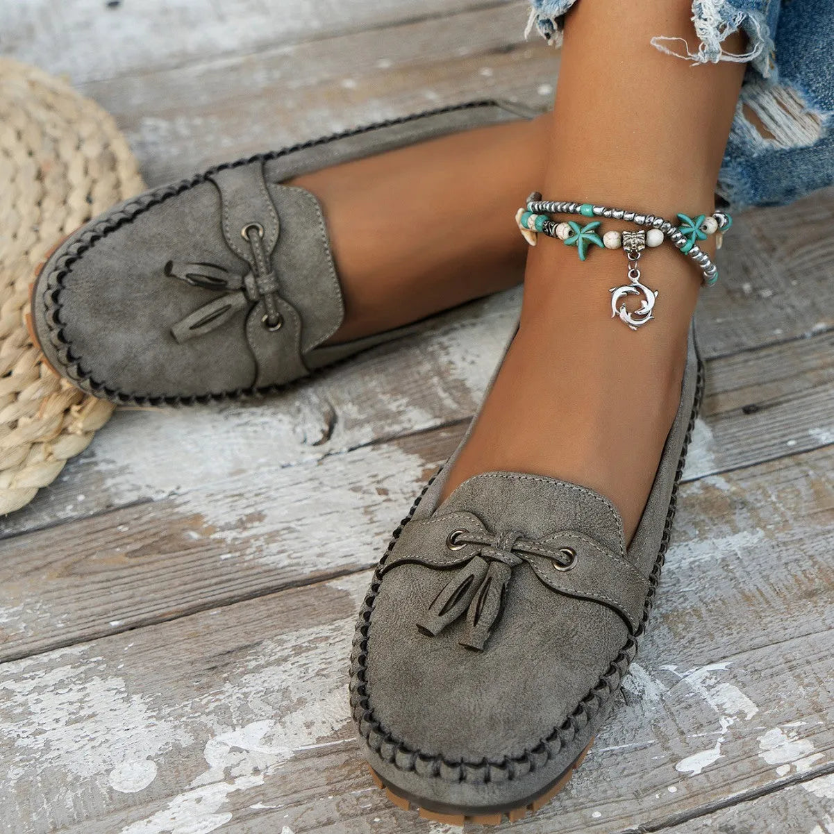 Women's solid colour suede flat shoes with a bow, shown in pink, apricot, grey, and blue on a casual background.