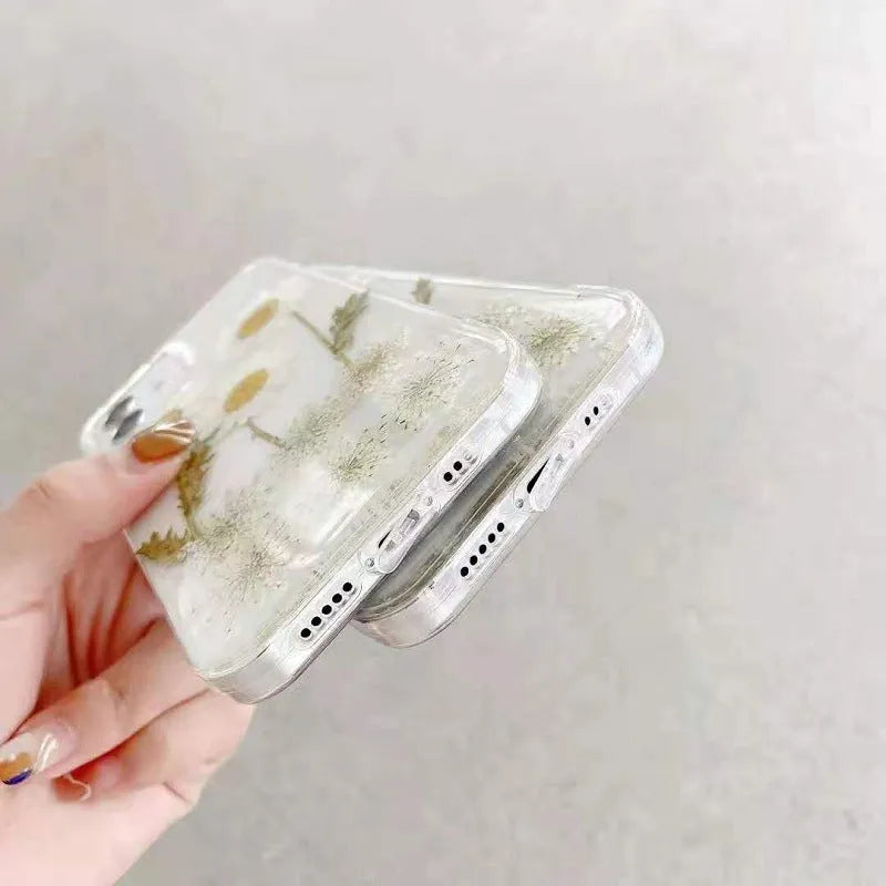 White TPU iPhone case with epoxy daisy floral pattern on back, shown on iPhone model