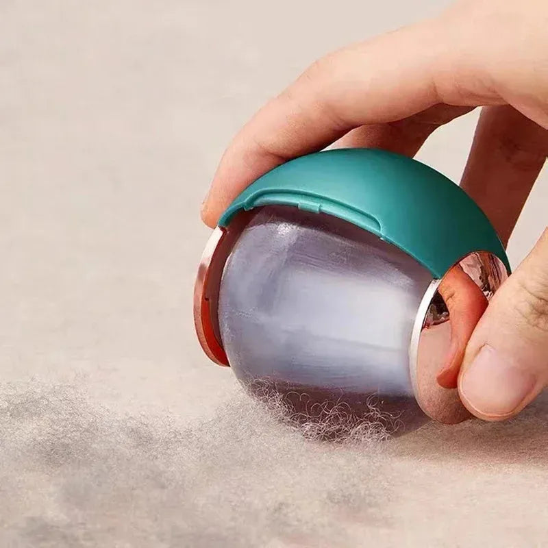 White reusable lint roller ball with handle for removing pet hair from fabric.