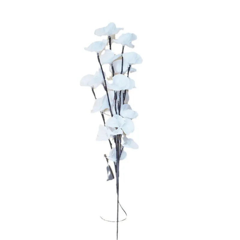 A 65cm long pink LED phalaenopsis branch decorative light on a dark background.