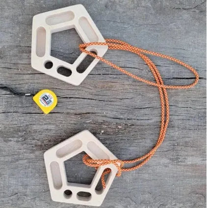 Birch wooden pentagonal-round climbing finger force training plate on a neutral background.