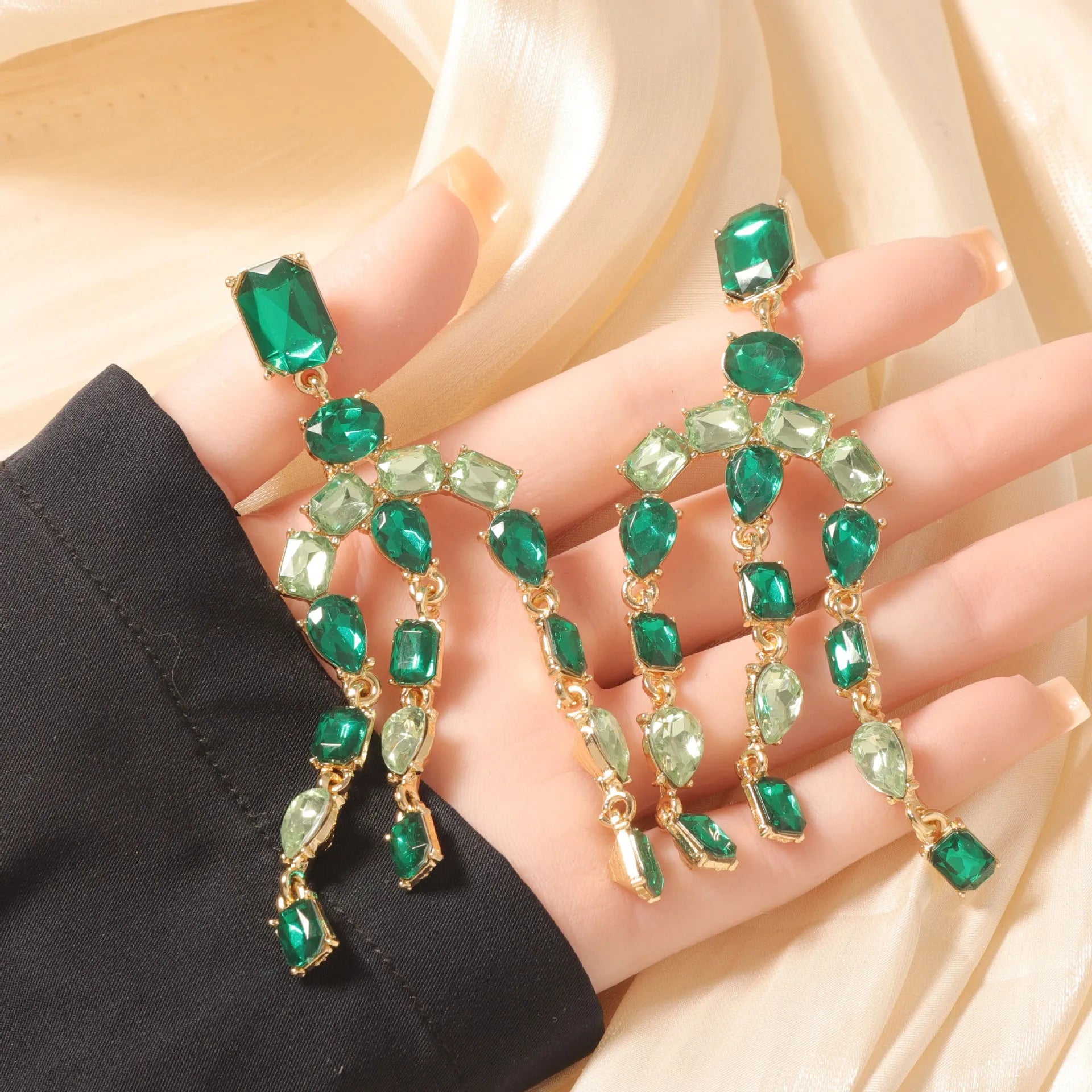 Heavy-duty full-drop diamond teardrop fringe earrings in zinc alloy, green colour, on display