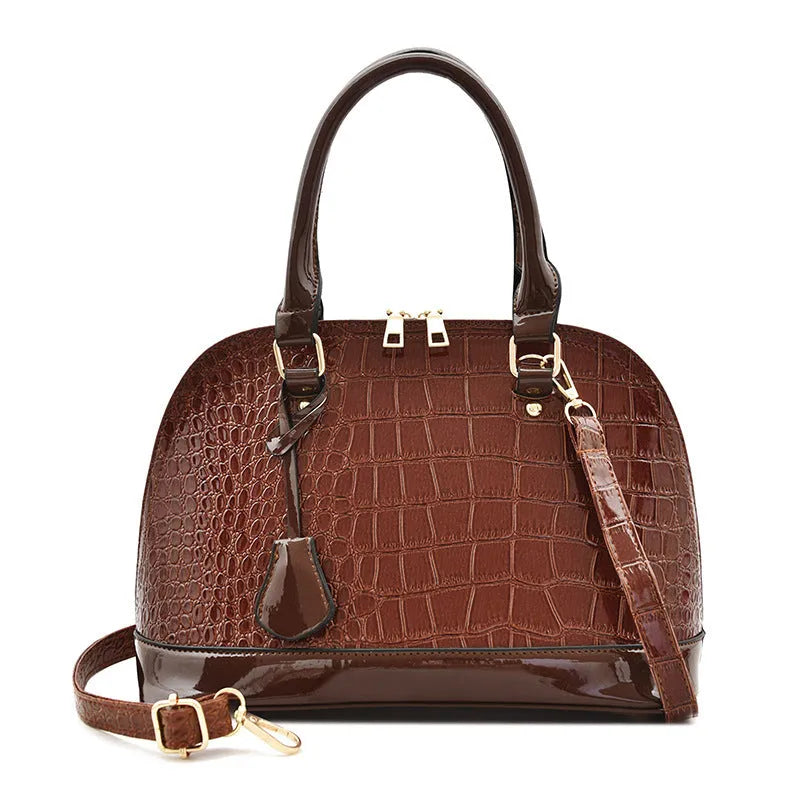 Shiny PU leather shell-shaped crossbody bag in black with dimensions 22x30x15cm