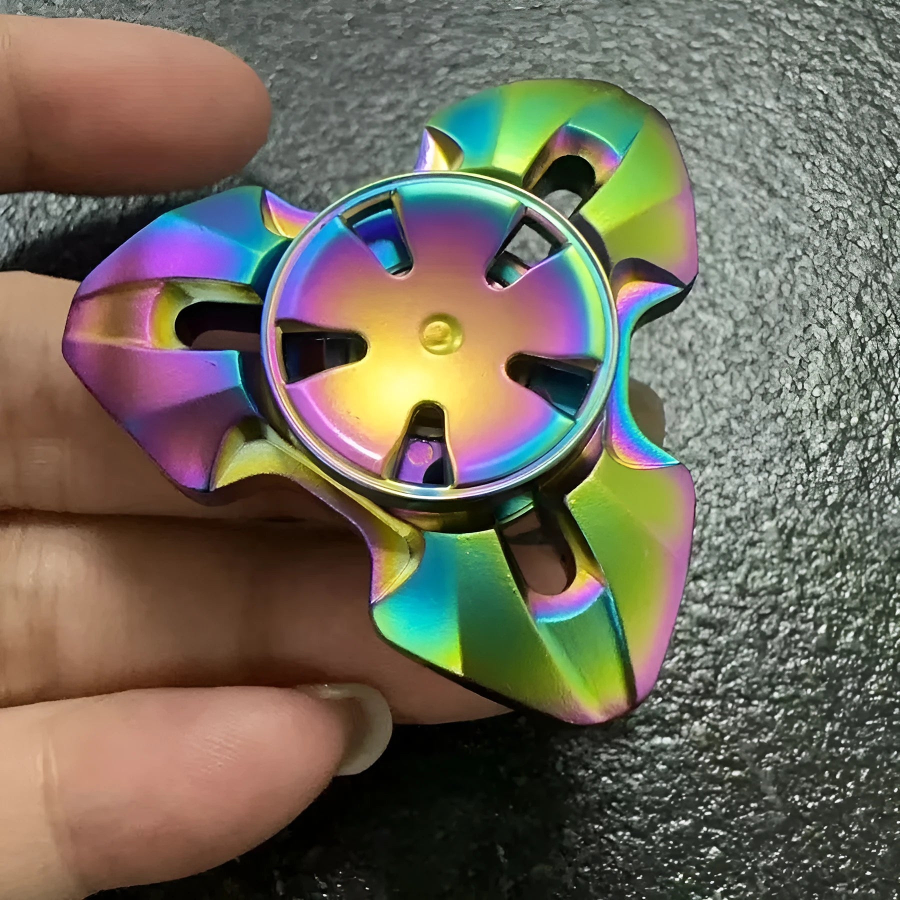 Metal alloy decompression toy with a rotating gyro, shown in gun colour and colourful options.