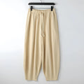 Man's linen harem pants with ankle ties in tapered cut, showing loose fit through thigh