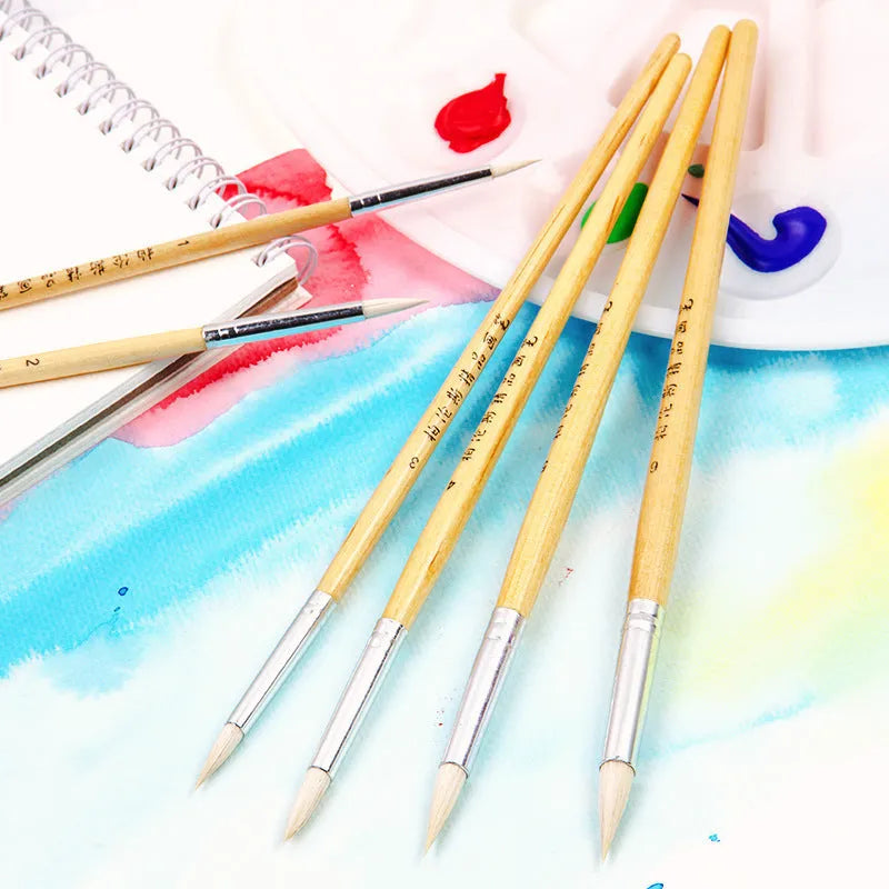 Set of six wooden-handled artist pen brushes with pointed tips on a white background.