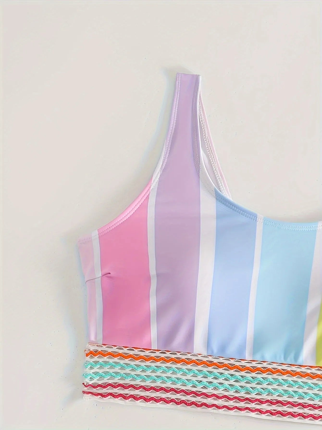 Striped women's bikini top and bottom set for sports swimming.