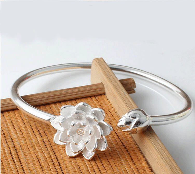 Snow Lotus silver open style bracelet on wrist showing lotus motif and electroplated finish