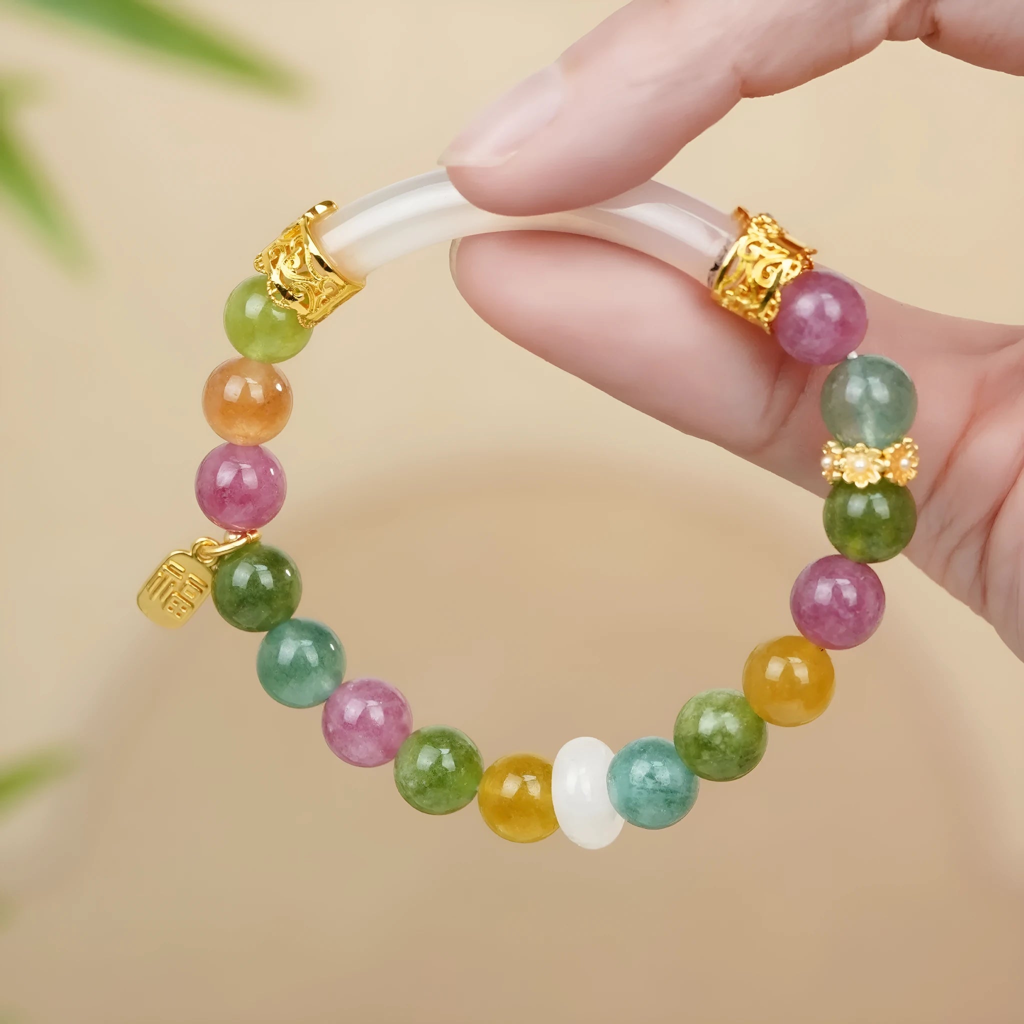 Rainbow coloured tourmaline half bracelet for women with an electroplated finish.