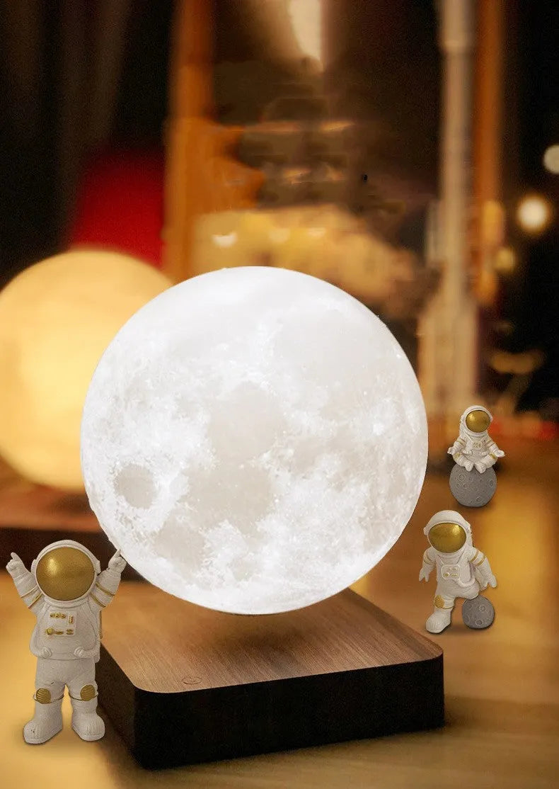 Maglev floating planet night light with astronaut figures on a base, showing USB cable.