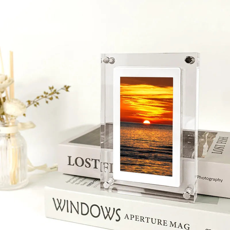 White acrylic digital picture frame with 5 inch vertical screen on a table