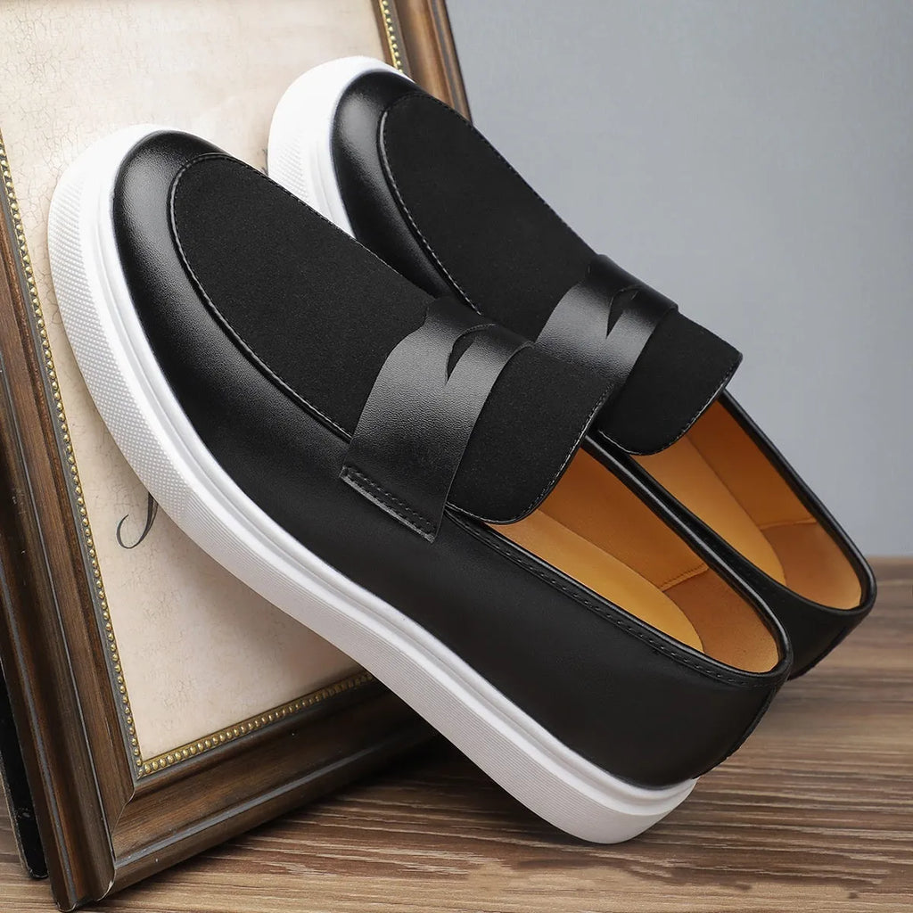 Black men's British-style slip-on casual shoes with a round toe and tassel detail on the upper.