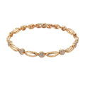 Golden hollow carved copper bracelet in a U-shape for women, showing detailed openwork design.