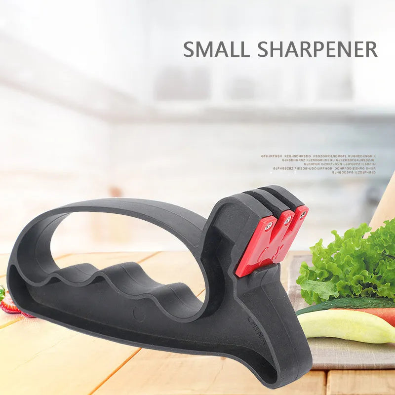 Black handheld knife and scissor sharpener showing ergonomic handle and sharpening slots on a white background.