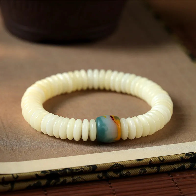 A white Bodhi seed bracelet shown in both a looped wrist style and a straight handheld style.