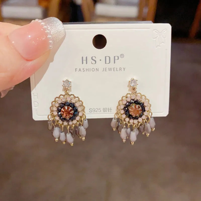 Round crystal tassel earrings with diamond embedded design and thick gold plating in blue or purple colour options