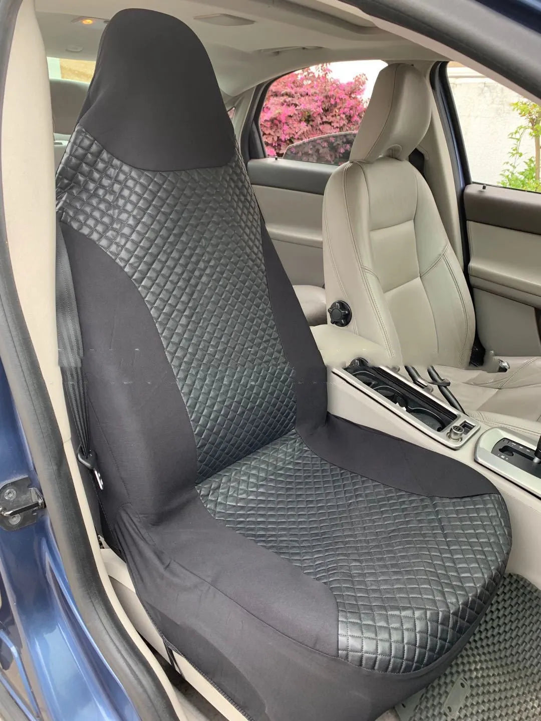 Black quilted automotive seat cover made of PU leather composite material with plastic hooks.