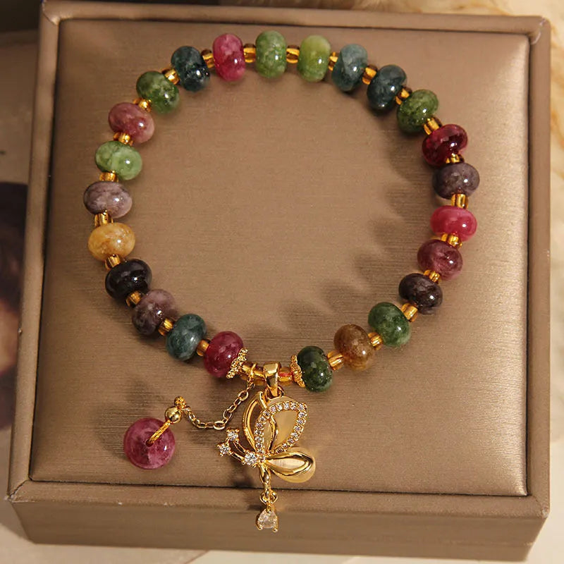 Colourful butterfly bracelet with alloy base and glass beads in tourmaline shades.