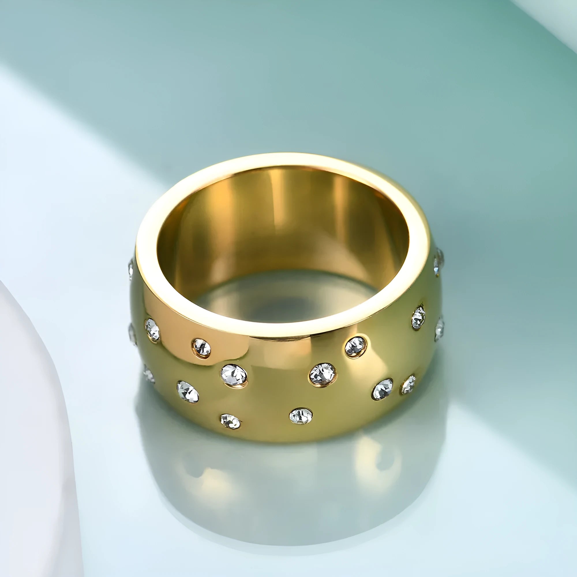 Geometric round titanium steel women's ring with diamond detailing shown in black, gold, rose gold, and steel colour finishes.