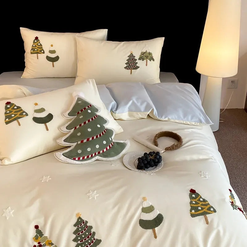 Pure cotton Christmas tree towel embroidery bedding four-piece set in cream blue on a bed.