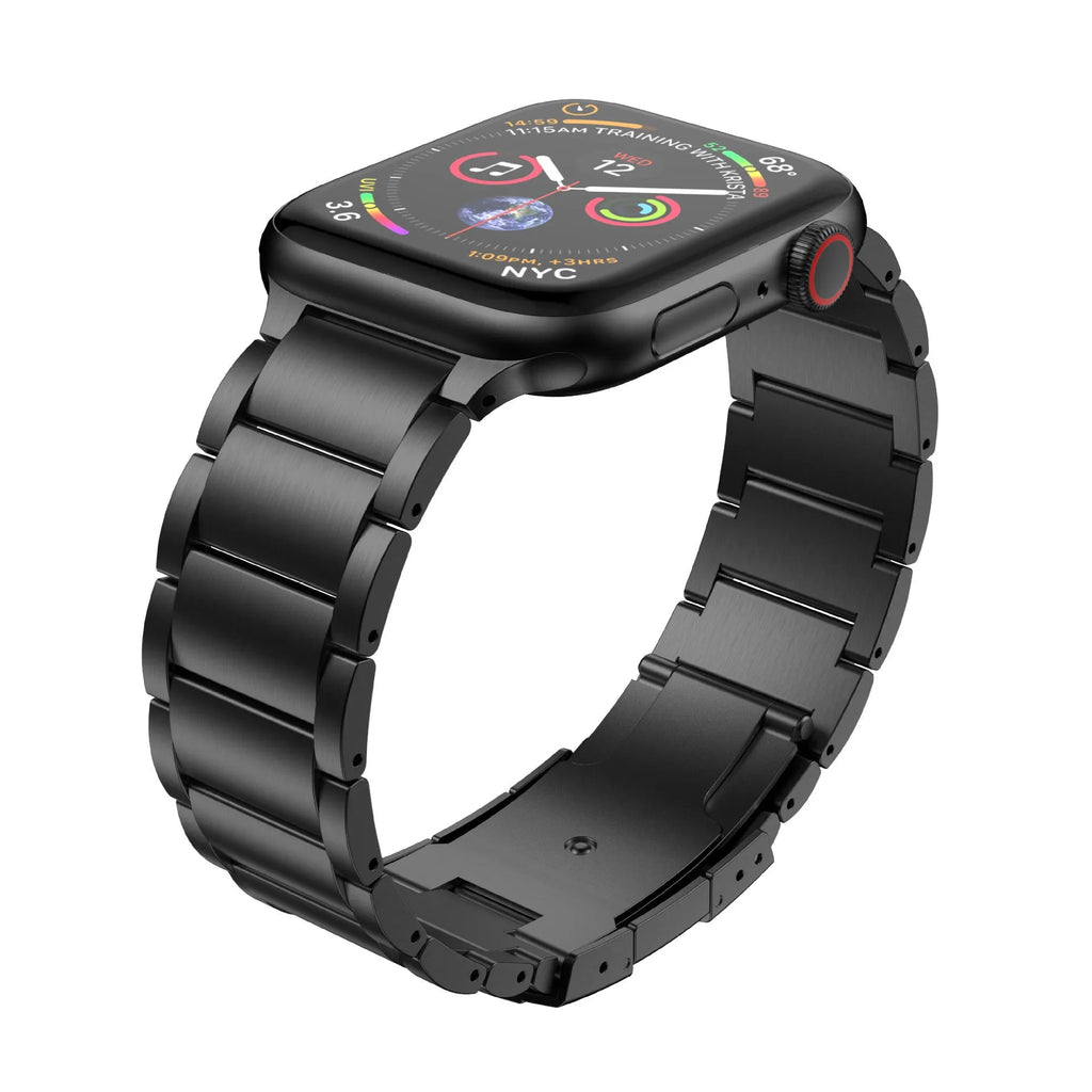Black titanium metal Apple Watch band with a folding buckle on a table