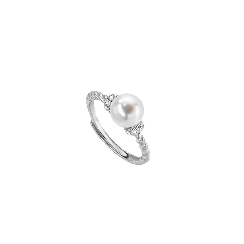 Adjustable antique twist copper ring with a geometric pearl centre in gold and silver colours.