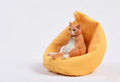 Resin lazy cat car ornament with fabric sofa, approximately 7.5cm high.