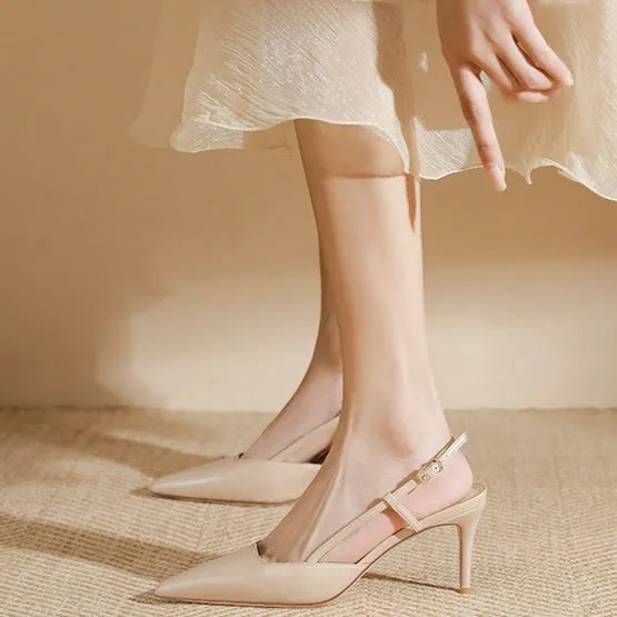 Women's apricot high-heeled sandals with a buckle on the toe strap and thin belts.