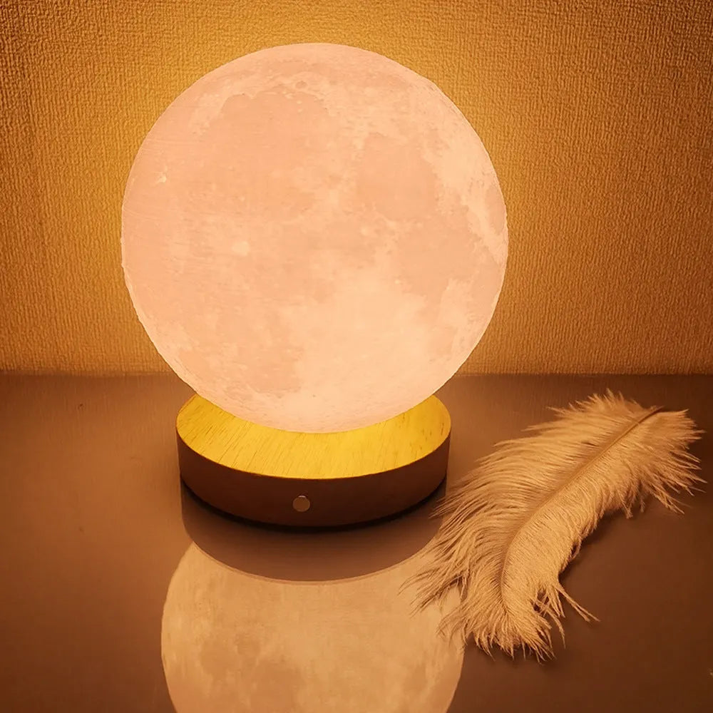 Rotating moon night light on wooden base showing three colour settings
